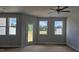 Bright living room featuring a ceiling fan, neutral paint, and a door leading to the outdoors at 3854 Well Fleet Drive, Fuquay Varina, NC 27526