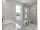 Bathroom features a double vanity, large shower, and a window overlooking the yard at 3860 Well Fleet Drive, Fuquay Varina, NC 27526