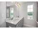 Bathroom featuring a double vanity, ample countertop space, large mirror and windows at 3860 Well Fleet Drive, Fuquay Varina, NC 27526