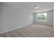 Bright bedroom featuring neutral carpet, a large window, and ample natural light at 3860 Well Fleet Drive, Fuquay Varina, NC 27526