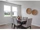 Elegant dining room featuring a modern table, comfortable seating, and stylish decor at 3860 Well Fleet Drive, Fuquay Varina, NC 27526