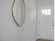 Bright foyer featuring a modern mirror, white door with glass panes, and light gray walls at 3860 Well Fleet Drive, Fuquay Varina, NC 27526