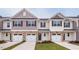 New townhomes boasting attached garages and manicured lawns at 3860 Well Fleet Drive, Fuquay Varina, NC 27526