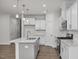 Well-equipped kitchen with stainless steel appliances, island, and white cabinets at 3860 Well Fleet Drive, Fuquay Varina, NC 27526