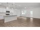 Bright, open-concept kitchen with stainless steel appliances and a large island with pendant lighting at 3860 Well Fleet Drive, Fuquay Varina, NC 27526