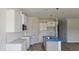 Modern kitchen featuring white cabinets, stylish backsplash, and stainless steel appliances at 3860 Well Fleet Drive, Fuquay Varina, NC 27526