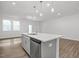 Modern kitchen with stainless steel dishwasher and large island with pendant lights at 3860 Well Fleet Drive, Fuquay Varina, NC 27526