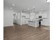 Open floor plan featuring a modern kitchen with stainless steel appliances and wood flooring at 3860 Well Fleet Drive, Fuquay Varina, NC 27526