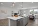 Open-concept kitchen with an island, stainless steel appliances, and an adjacent dining area at 3860 Well Fleet Drive, Fuquay Varina, NC 27526