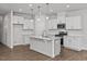 Modern kitchen with island, stainless steel appliances, and white cabinets at 3860 Well Fleet Drive, Fuquay Varina, NC 27526