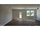 Spacious living room with an exterior door and natural light pouring through the windows at 3860 Well Fleet Drive, Fuquay Varina, NC 27526