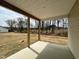 Back porch with ceiling and wood beam posts overlooking back yard at 394 Maidenhair Pl, Clayton, NC 27520
