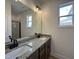 Bathroom with double sink vanity, granite counters, and modern fixtures at 394 Maidenhair Pl, Clayton, NC 27520