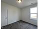 This bedroom has carpeted floors, a window, and a modern light fixture at 394 Maidenhair Pl, Clayton, NC 27520