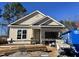 New construction home with a brick garage and tan siding at 394 Maidenhair Pl, Clayton, NC 27520