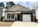 Charming single-story home features a brick-accented garage and neutral color palette at 394 Maidenhair Pl, Clayton, NC 27520