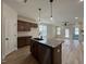 Open-concept kitchen with granite island flows into a spacious living area at 394 Maidenhair Pl, Clayton, NC 27520