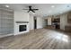 Open layout features a fireplace, built-ins, and seamless connection to the kitchen at 394 Maidenhair Pl, Clayton, NC 27520