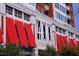 Close-up of building exterior with red awnings, the building number and tree-lined street at 400 W North St # 620, Raleigh, NC 27603