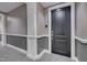 Hallway with apartment door, wall paneling, and gray carpet at 400 W North St # 620, Raleigh, NC 27603