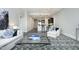 Open-concept living room leading to the kitchen, featuring a sofa and large area rug at 400 W North St # 620, Raleigh, NC 27603