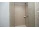 Close-up of the shower with neutral tile, glass door, and modern fixtures at 400 W North St # 620, Raleigh, NC 27603