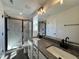 Modern bathroom boasts a double vanity, granite countertops, and a tiled shower with a glass door at 406 Maidenhair Pl, Clayton, NC 27520