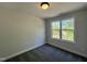 Simple bedroom with carpet floors and natural light from the window at 406 Maidenhair Pl, Clayton, NC 27520