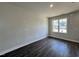 Neutral bedroom with wood floors and natural light from the window at 406 Maidenhair Pl, Clayton, NC 27520