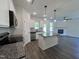 Open-concept kitchen showcases granite countertops, a center island, and stainless steel appliances at 406 Maidenhair Pl, Clayton, NC 27520