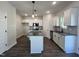 Bright kitchen features white cabinets, granite countertops, a kitchen island, and stainless steel appliances at 406 Maidenhair Pl, Clayton, NC 27520
