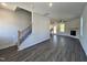 Spacious living area with wood floors, staircase and views into the kitchen and fireplace at 406 Maidenhair Pl, Clayton, NC 27520
