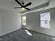 Bright primary bedroom with tray ceilings, a ceiling fan, carpet flooring and natural light from the two windows at 406 Maidenhair Pl, Clayton, NC 27520