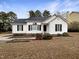 White house with landscaping, walkway, and a neatly kept lawn at 4109 Mangrove Dr, Raleigh, NC 27616