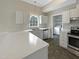 Kitchen with white cabinets, a large island, and stainless steel appliances at 4109 Mangrove Dr, Raleigh, NC 27616