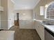 Eat-in kitchen with white cabinets, island, and stainless steel appliances at 4109 Mangrove Dr, Raleigh, NC 27616