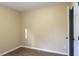 Simple bedroom with light walls, wood-look floors, and a closet at 412 N Cooper St, Clayton, NC 27520