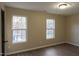 Spacious bedroom with hardwood floors and two large windows at 412 N Cooper St, Clayton, NC 27520