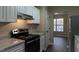 Modern kitchen with stainless steel appliances and white cabinets at 412 N Cooper St, Clayton, NC 27520