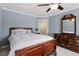 Comfortable bedroom with wood furniture and ceiling fan at 4309 Riverport Rd, Raleigh, NC 27616