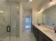 The bathroom offers a walk-in shower with tile, a dual sink vanity and an open doorway at 4318 Emeline Ln # 20, Fuquay Varina, NC 27526