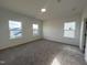 A light-filled bedroom features neutral carpet, three windows, and white walls at 4318 Emeline Ln # 20, Fuquay Varina, NC 27526