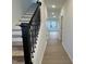 Bright entryway featuring hardwood floors, a staircase with modern railings and neutral paint at 4318 Emeline Ln # 20, Fuquay Varina, NC 27526