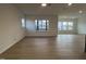 Spacious living room with hardwood floors, large windows, and neutral paint at 4318 Emeline Ln # 20, Fuquay Varina, NC 27526