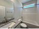 Bathroom featuring granite vanity top, tub, and shower at 45 Mossman Ct, Zebulon, NC 27597