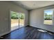 Bright bedroom with hardwood flooring, a sliding glass door to a deck, and a large window at 45 Mossman Ct, Zebulon, NC 27597