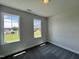 Cozy bedroom with two windows, carpeted floors, and neutral walls at 45 Mossman Ct, Zebulon, NC 27597