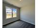 Neutral bedroom with a large window and carpeted floors at 45 Mossman Ct, Zebulon, NC 27597