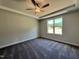 Comfortable bedroom with plush carpeting, a ceiling fan, and a window with a view of the outdoors at 45 Mossman Ct, Zebulon, NC 27597