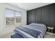 Bedroom with dark accent wall and striped bedding at 4605 All Points View Way, Raleigh, NC 27614